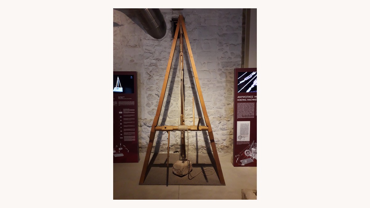 Ancient Greek tripod crane reconstruction lifting a stone